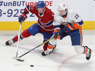 Montreal's Brett Kulak (17) goes for puck with New York Islanders' Mathew Barzal (13) during first period NHL action in Montreal on Tuesday December 03, 2019.