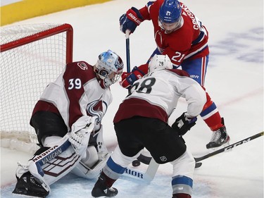 Montreal Canadiens Nick Cousins (21) shoots on Colorado Avalanche goaltender Pavel Francouz in fron of Ian Cole (28), during first period NHL action in Montreal on Thursday December 05, 2019.