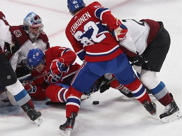 Brendan Gallagher (11) falls in front of Colorado Avalanche goaltender Pavel Francouz, while Artturi Lehkonen (62) tries to get to the puck before Nathan MacKinnon (29), during first period NHL action in Montreal on Thursday December 05, 2019.