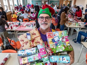 Sylvain Duhamel, Chief Elf Officer (CEO) of the Little Elves Foundation, and helpers wrap gifts for isolated or underprivileged people on Saturday, Dec. 7, 2019.