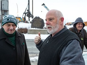 A small group, including Fergus Keyes (director of Montreal Irish Monument Park Foundation), Victor Boyle (president of the Ancient Order of Hibernians) and Donovan King, left to right, gathered at the Black Rock monument in Montreal on Sunday Dec. 8, 2019 to share thoughts and prayers for those who lie buried at the Black Rock Irish Famine Cemetery.