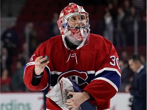 Canadiens rookie goaltender Cayden Primeau throws pucks to the crowd after being named the game's first star Wednesday night.