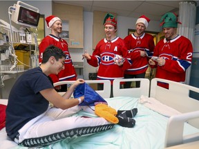 Montreal Canadiens' Brendan Gallagher kids with Faci Mohamed Malik while visiting his room with teammates Paul Byron, left, Christian Folin and Nick Cousins, right, during the team's annual Christmas visit to the Montreal Children's Hospital on Thursday, Dec. 12, 2019.