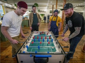 James Simpkins, left, and Derek Dammann take a foosball break at McKiernan Luncheonette as Chris Morgan, rear left, and Derrick Reinhardt look on.