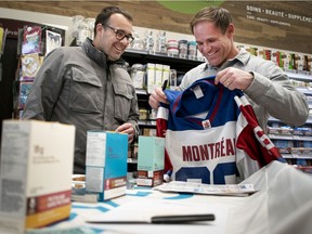 Carl Poisson, left, gets a jersey signed by former Als receiver Ben Cahoon in Montreal, on Friday, Dec. 13, 2019.