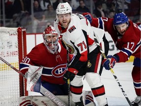 Montreal Canadiens defenceman Brett Kulak clears Ottawa Senators' Chris Tierney from Cayden Primeau's crease in Montreal on Dec. 11, 2019.