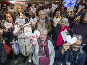 Members and supporters of the YMCA Guy-Favreau hold up paper hearts during noon-time rally to try to save the community centre from closing, in Montreal Thursday December 19, 2019.