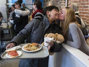 Elisapee Carol Annanack (left) gets a kiss from Crystal Kelly at a special Italian-themed Christmas Eve lunch at Chez Doris in Montreal on Saturday,  December 21, 2019.