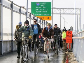 Jim McDermott, left, leads a group of about 100 Montrealers across the new Samuel De Champlain Bridge at the opening of the multi-use pedestrian and bike path that connects to the South Shore, in Montreal Monday Dec. 23, 2019.