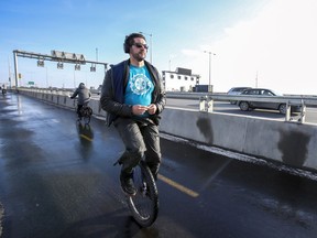 Karim Kammah rides a unicyle on the multi-use path on the new Samuel De Champlain Bridge in Montreal Monday Dec. 23, 2019.