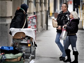 Marcel and Nathalie Roy of Riguad deliver homemade food and gifts to homeless people downtown on Christmas morning.