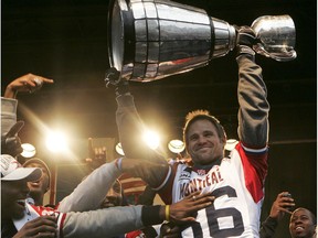 Alouettes' Ben Cahoon hoists the Grey Cup after parade down Ste-Catherine St. on Dec. 1, 2010.