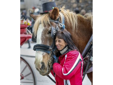 Caleche driver Nathalie Matte poses for a photo with her horse Knockout in Old Montreal on Sunday, Dec. 29, 2019.
