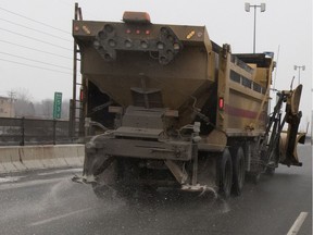 A snow removal truck salts highway 20 in the Dorval district of Montreal on Saturday January 16, 2016.