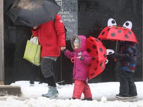 Parent walks kids back from school after learning that Montreal schools were closed for the day on Thursday, Jan. 24, 2019. (Pierre Obendrauf / Montreal Gazette)