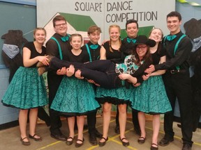 The Richmond 4-H square dance troupe holds up teacher Erin Scoble at a competition.