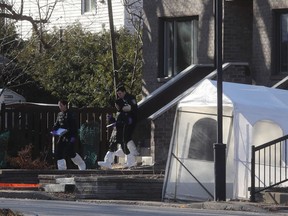 Police inspectors leave house where three bodies were found in Pointe-aux-Trembles on Dec. 11, 2019.