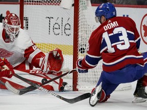 Canadiens' Max Domi falls to the ice as he shoots on Detroit Red Wings goaltender Jonathan Bernier at the Bell Centre on Saturday, Dec. 14, 2019.