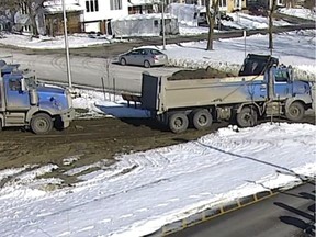 A still from surveillance video provided by Laval police shows two trucks at the Cité de la santé hospital in Laval's Vimont district. Police say the trucks illegally dumped waste at the site.