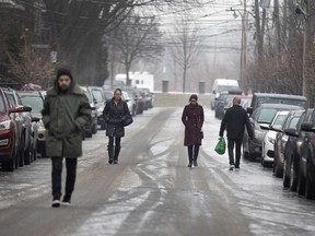 Pedestrians walk up 4th Ave. in Verdun because the sidewalks are covered in ice Dec. 27, 2019.