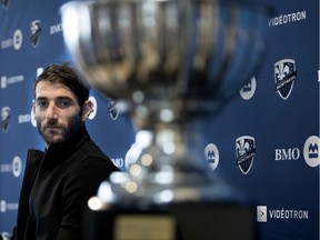 Montreal Impact Ignacio Piatti looks at his MVP trophy during a news conference in Montreal on Oct. 31, 2018.