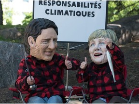 Members of Oxfam dressed as the G7 leaders protest in Quebec City on June 9, 2018, during the G7 Summit.