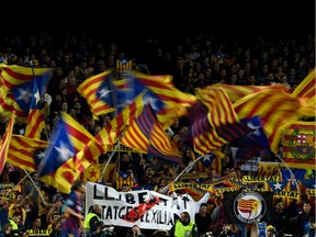 Barcelona's supporters wave Catalan pro-independence "Estelada" flags and a banner reading "freedom for political prisoners" during the UEFA Champions League Group F football match between FC Barcelona and Borussia Dortmund at the Camp Nou stadium in Barcelona, on November 27, 2019.