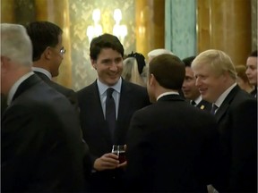 This grab made from a video shows Dutch Prime Minister Mark Rutte (L), French President Emmanuel Macron (front), British Prime Minister Boris Johnson (R) and Canadian Prime Minister Justin Trudeau at a Buckingham Palace reception mocking US President Donald Trump's lengthy media appearances ahead of the NATO summit on December 3, 2019 in London.