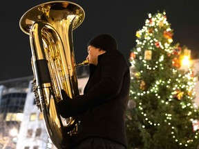 A member of the Rudersdorf Music Society brass band plays a Christmas carols with his tuba at the small Christmas market in Vienna's Mariahilfer Street on December 9, 2019 in Vienna, Austria. "Whether we create music, play it or actively listen to it, we effectively participate in a transcendent experience," Kevin Richard writes.