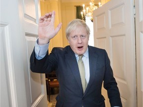 Britain's Prime Minister and Conservative Party leader Boris Johnson is greeted by staff as he arrives back at 10 Downing Street in central London on December 13, 2019, following an audience with Britain's Queen Elizabeth II at Buckingham Palace, where she invited him to become Prime Minister and form a new government.