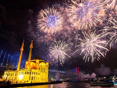 Fireworks explode in the sky over the Ortakoy Mosque by the July 15 Martyrs' Bridge during the New Year's celebrations, in Istanbul on January 1, 2020. (Photo by Yasin AKGUL / AFP)