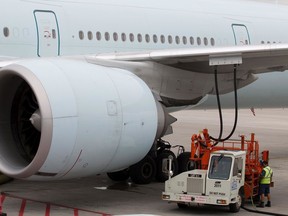 A ground crew worker fuels a jet at Montreal's Trudeau Airport in Montreal.