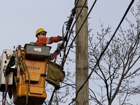Hydro-Québec crews repair power lines that were torn down during a recent storm on Sunday May 6, 2018.