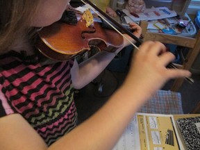 Ryan, a "gender variant" fourth grader, plays the violin at her home in Illinois. Ryan's parents — initially told Ryan had "gender identity disorder," the now-outdated diagnosis — tried to get their child more interested in traditional boy things. But nothing changed. Eventually, they decided to stop resisting and allowed Ryan to start taking small steps into the outside world.