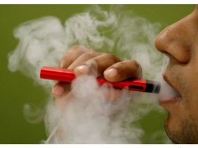 A man uses a vape device in this illustration picture, Sept. 19, 2019.