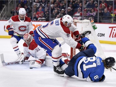 Winnipeg Jets' Kyle Connor (81) is checked by Montreal Canadiens' Shea Weber (6) after goaltender Carey Price (31) made the save on a breakaway during second period NHL action in Winnipeg on Monday Dec. 23, 2019.