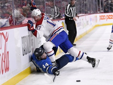 Winnipeg Jets' Josh Morrissey (44) is checked into the boards by Montreal Canadiens' Brett Kulak (17) during second period NHL action in Winnipeg on Monday Dec. 23, 2019.