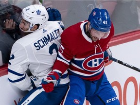 Jordan Schmaltz of the Toronto Maple leafs is rammed into the boards by Riley Barber of the Montreal Canadiens during pre-season action in Montreal on Monday, Sept. 23, 2019.