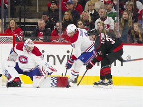 Canadiens goaltender Charlie Lindgren and  defenceman Ben Chiarot  stop the first-period shot by Carolina Hurricanes' Andrei Svechnikov at PNC Arena.