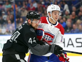 Montreal Canadiens center Jesperi Kotkaniemi (15) and Tampa Bay Lightning defenseman Jan Rutta (44) fight to control the puck during the first period at Amalie Arena.