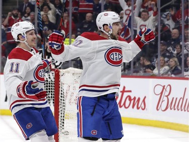 Montreal Canadiens left wing Tomas Tatar (90) celebrates with right wing Brendan Gallagher (11) after scoring a first period goal against the Winnipeg Jets at Bell MTS Place on Dec. 23, 2019.