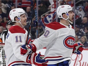The Canadiens’ Tomas Tatar (right) celebrates with lineman Brendan Gallagher after scoring a first-period goal during NHL game against the Jets at Bell MTS Place in Winnipeg on Dec. 23, 2019.