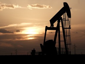 Oil pump jack works at sunset near Midland, Tex., on August 21, 2019.