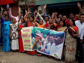People shout slogans as they celebrate after police shot dead four men suspected of raping and killing a 27-year-old veterinarian in Telangana, in a residential area in Ahmedabad, India, December 6, 2019.