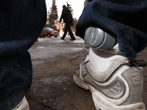 A location bracelet is seen on the ankle of a man on probation.