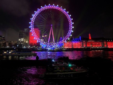 A police boat patrols the Thames river in front of the London Eye ahead of the New Year's fireworks event, in central London, Britain December 31, 2019. REUTERS/Toby Melville