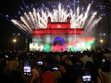 People record fireworks on mobile phones at the Gateway of India monument on New Year's Day in Mumbai, India, January, 1, 2020. REUTERS/Francis Mascarenhas