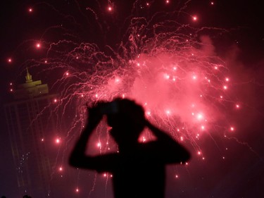 A man takes pictures of the fireworks during the New Year's celebrations in Colombo, Sri Lanka December 31, 2019. REUTERS/Dinuka Liyanawatte