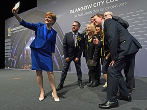 Scottish National Party leader Nicola Sturgeon takes a selfie with her newly elected MPs in Glasgow on Friday, Dec. 13, 2019, after results were declared in the U.K. general election.