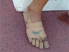 Rhea Bullos, 11, wears tape as makeshift running shoes during a 1500-meter run at the Iloilo Sports Complex, in Iloilo, Philippines December 9, 2019. Picture taken December 9, 2019. Predirick Valenzuela/Handout via REUTERS